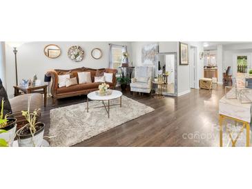 Cozy living room showcasing hardwood floors, elegant furnishings, and a well-lit, inviting atmosphere at 2011 Dunsmore Ln # 137, Waxhaw, NC 28173