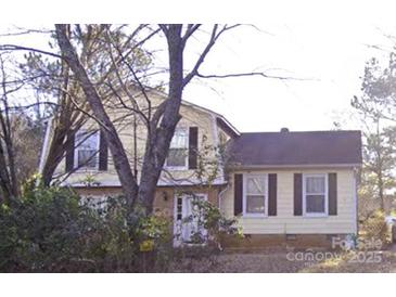 Charming two-story home with a traditional design and a well-maintained front yard partially obscured by trees at 2508 Wood Star Ct, Matthews, NC 28105