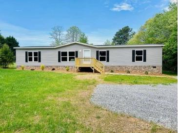 Charming one-story home with gray siding, black shutters, and a well-maintained front yard at 3144 Rickwood Dr, Newton, NC 28658