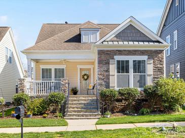 Charming home with stone accents, front porch, and landscaped yard at 4434 Patriots Hill Rd, Mint Hill, NC 28227