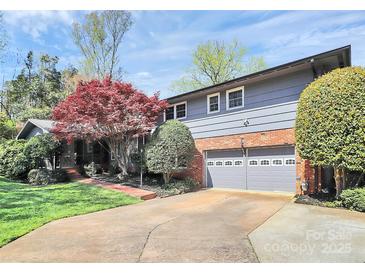 Beautiful home with a two-car garage, manicured lawn, and vibrant landscaping at 501 Eastwood Dr, Gastonia, NC 28054