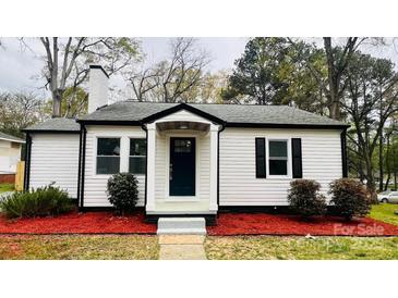 Charming, updated cottage-style home with a freshly painted exterior and manicured landscaping at 609 Mccarten St, Monroe, NC 28112