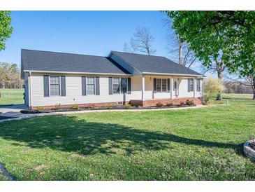 Traditional home boasting black shuttered windows, green lawn, and charming curb appeal at 121 Wichita Dr, Shelby, NC 28152