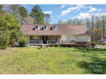 Charming home featuring a welcoming front porch, well-kept lawn, and traditional architectural details at 306 Nance Rd, Charlotte, NC 28214