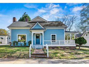 Charming blue home with a welcoming front porch and well-maintained lawn at 311 W Center Ave, Mooresville, NC 28115