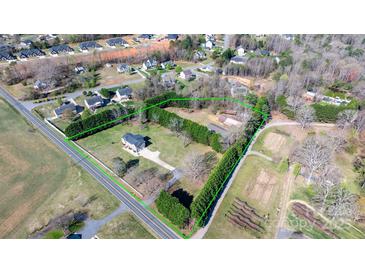 A captivating aerial view of a property with well-maintained landscaping and a long driveway in a suburban neighborhood at 4875 Sulpher Springs Ne Rd, Hickory, NC 28601