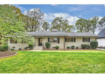 Charming brick home with a well-manicured lawn and lush landscaping at 500 Lansdowne Rd, Charlotte, NC 28270