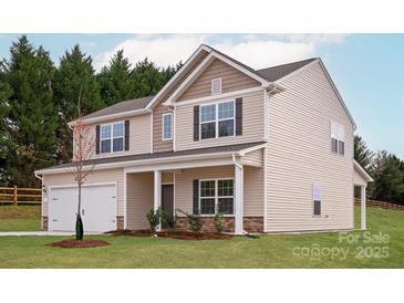 Charming two-story home featuring beige siding, dark shutters, and a welcoming front porch at 5703 Skinny Dr, Charlotte, NC 28215