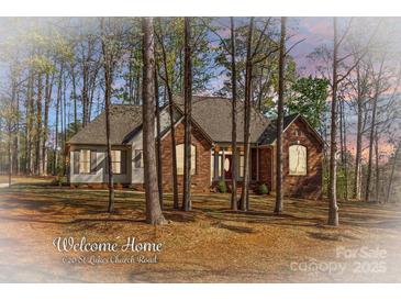 Charming single-story brick home featuring a well-maintained lawn and mature trees at 620 St Lukes Church Rd, Salisbury, NC 28146