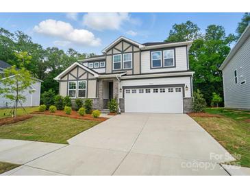 Beautiful two-story home with modern architecture, manicured lawn and a two car garage at 9957 Cask Way, Huntersville, NC 28078