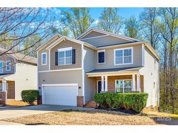 Charming two-story home with attached garage and manicured front landscaping at 1929 Shorthorn St, Charlotte, NC 28213