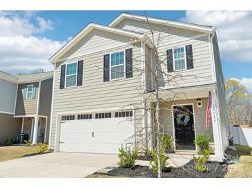 Charming two-story home with a well-maintained lawn, attached garage, and a welcoming front entrance at 2027 Redstone Dr, York, SC 29745