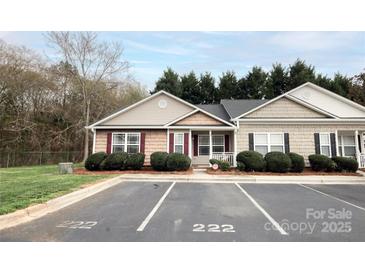 Charming townhouse featuring classic colors, manicured bushes, and reserved parking spots at 222 Baldwin Ct, Rock Hill, SC 29730