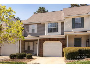 Charming townhouse featuring a brick facade, attached garage, and well-maintained landscaping at 4548 Antelope Ln, Charlotte, NC 28269