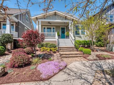 Charming home featuring a quaint porch, beautiful landscaping, and a colorful flower garden at 815 Digby Rd, Rock Hill, SC 29730