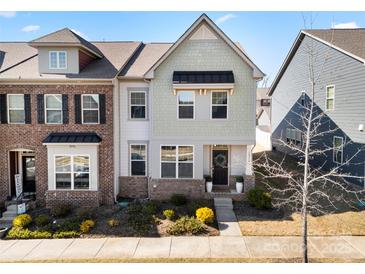 Charming townhome with a well-maintained front yard and inviting entrance, showcasing curb appeal at 10914 Zac Hill Rd, Davidson, NC 28036