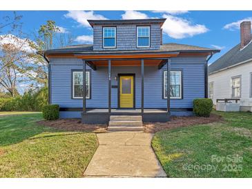Charming two-story home showcasing blue siding, a yellow front door, and a welcoming covered front porch at 126 E Henderson St, Salisbury, NC 28144