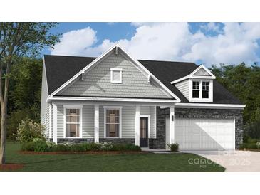 Charming single-Gathering home featuring a stone facade, gray siding, and a two-car garage at 2041 Mantle Ridge Dr, Indian Trail, NC 28079