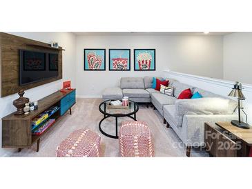 Cozy living room area with large couch, decorative art, and entertainment console at 4231 Steel Way, Sherrills Ford, NC 28673