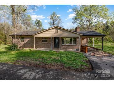 Charming single-story brick home with a covered front porch, attached carport, and a cozy, inviting atmosphere at 518 W Westview St, Gastonia, NC 28052