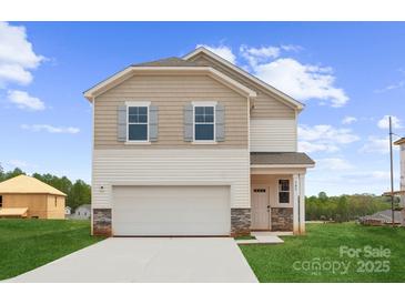 Charming two-story home featuring a two-car garage, stone accents, and well-manicured lawn at 706 Olde England Dr, Lincolnton, NC 28092