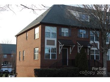 Charming townhome with brick facade, mature landscaping, and inviting front entrance at 121 Irving Ave # A, Mooresville, NC 28117