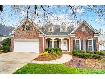 Charming brick home featuring manicured landscaping, inviting entryway, and two-car garage at 1509 Burning Lantern Ln, Kannapolis, NC 28081