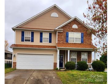 Charming two-story home with blue shutters, stone accents, attached garage, and landscaped yard at 16306 Hayfield Rd, Charlotte, NC 28213