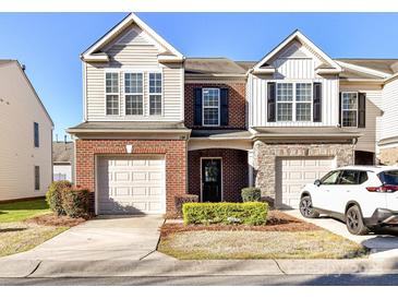 Charming two-story home features a well-maintained front yard and two-car garage at 2240 Kensington Station Pkwy, Charlotte, NC 28210