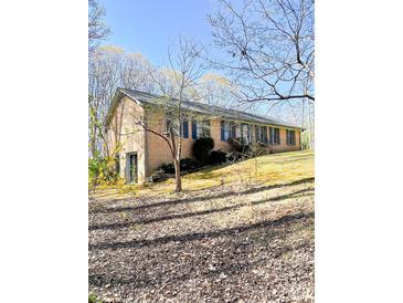 Brick home on a sloped lot with a side entry garage at 453 Cotton Ct, York, SC 29745