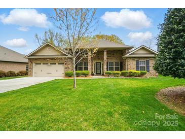 Charming single Gathering home with a well manicured lawn and attached two car garage at 5032 Eagles Crest Ln, Gastonia, NC 28056