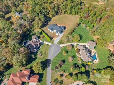 Overhead view of a neighborhood featuring modern homes with a lush, wooded backdrop at 5039 Eliza Long Wilkie Dr, Huntersville, NC 28078