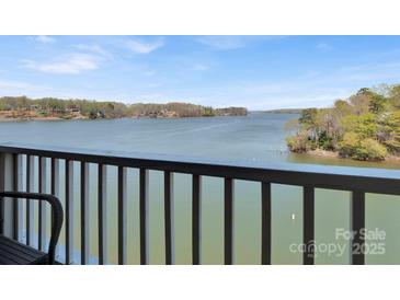 Scenic lake view from a balcony with tranquil waters and lush greenery, offering serene outdoor living at 9808 Emerald Point Dr # 10, Charlotte, NC 28278
