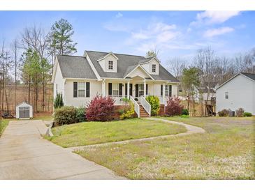 Charming two-story home with a welcoming front porch and well-maintained landscaping at 123 Scotch Irish Ln # 136, Troutman, NC 28166