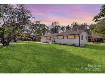Charming single-story home with a well-manicured lawn and a lovely, inviting exterior at 1315 Vickie Ln, Matthews, NC 28104