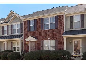 Inviting brick townhome featuring a well-maintained lawn and neutral exterior trim at 3048 Misty Harbor Cir # E, Cramerton, NC 28032