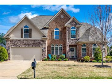 Beautiful two-story brick home with manicured lawn and arched windows at 324 Kerrydale Ct # 106, Clover, SC 29710