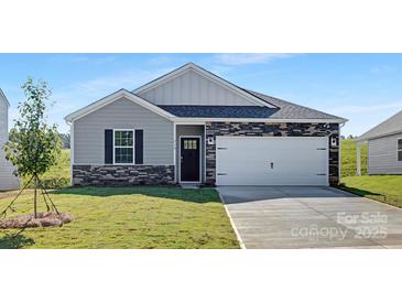 Charming single-story home with stone accents, gray siding, and a well-manicured front lawn at 3543 Cramer Creek Dr, Gastonia, NC 28056