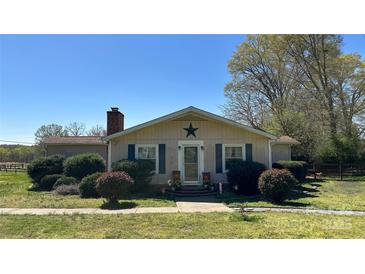 Charming single-story home with a chimney, front lawn, and landscaping at 4807 Lon Parker Rd # 1, Waxhaw, NC 28173