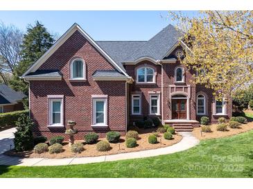 Stunning brick home boasts meticulous landscaping and architectural details like arched windows at 880 Craigmont Nw Ln, Concord, NC 28027