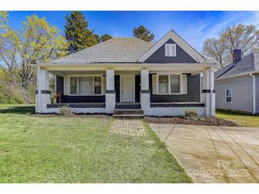 Charming single-story home featuring a covered front porch and well-maintained lawn in a quiet neighborhood at 209 N Yadkin Ave, Spencer, NC 28159