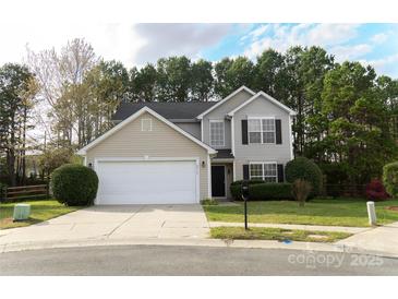 Charming two-story home featuring manicured front yard and attached two-car garage with large driveway at 2919 Bridgeville Ln, Charlotte, NC 28262