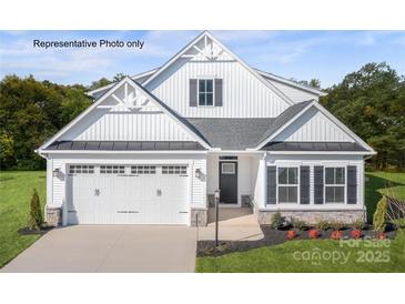 Charming two-story home with a two-car garage, manicured lawn, and classic white facade at 3008 Bramble Hedge Dr # 3272, Indian Trail, NC 28079