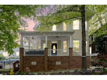 Charming two-story home with a welcoming front porch, brick base and ample natural light at 734 E 10Th St, Charlotte, NC 28202