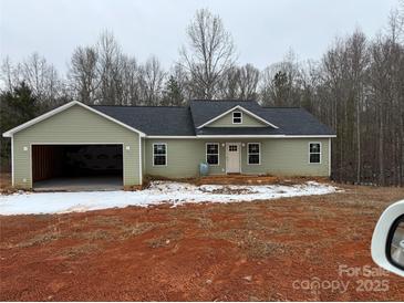 Charming one-story home with an attached two car garage, set on a spacious lot with a new front porch at 1127 Mckay Rd, Newton, NC 28658