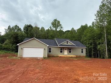 Charming one-story home with attached garage, covered front porch, and picturesque wooded surroundings at 1127 Mckay Rd, Newton, NC 28658