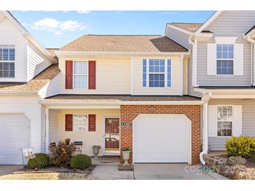 Charming two-story home with a brick facade, front-facing garage, and well-maintained landscaping at 11507 Rabbit Ridge Rd, Charlotte, NC 28270