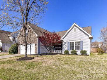 Charming single-Gathering home with a two-car garage, stone accents, and a well-maintained lawn at 15506 Lakepoint Forest Dr, Charlotte, NC 28278