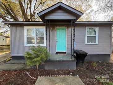 Charming home featuring a vibrant blue front door and gray siding at 3316 Queens Ln # 10, Gastonia, NC 28052