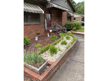 Charming brick home with a well-manicured front yard and walkway at 4331 Knollcrest Dr, Charlotte, NC 28208